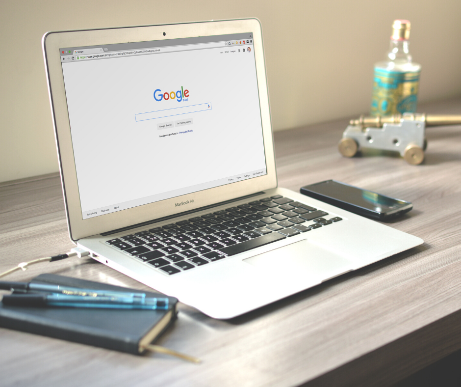 A computer on a desk with the Google homepage on display