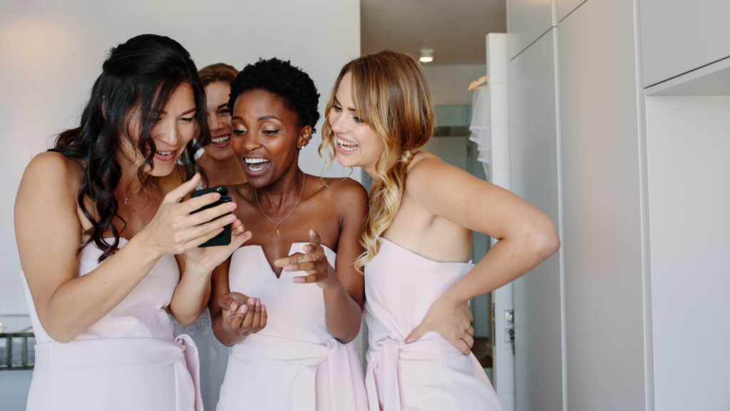 Bride and bridesmaids checking out social media feeds